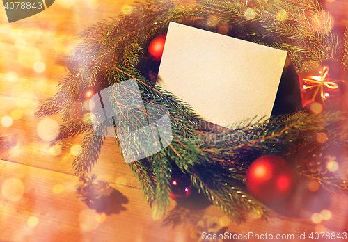 Image of natural green fir wreath with note on wooden board