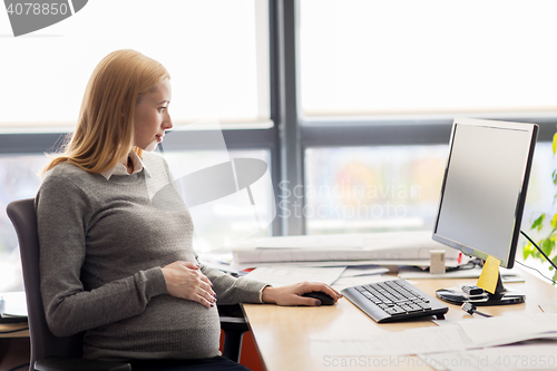 Image of pregnant businesswoman with computer at office