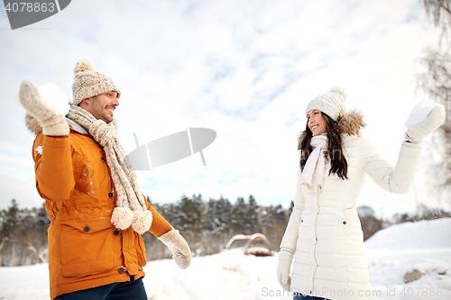 Image of happy couple playing snowballs in winter