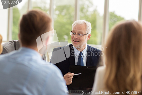 Image of business people with laptop meeting in office