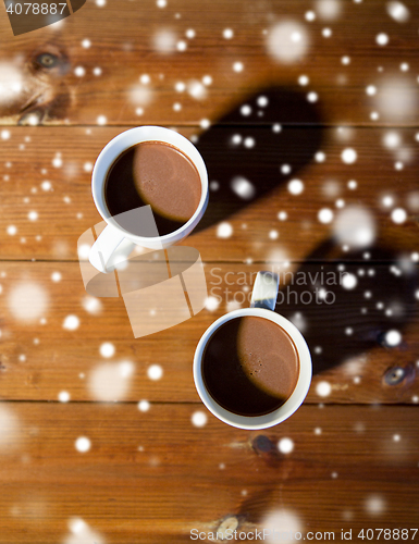 Image of cups of hot chocolate or cocoa drinks on wood