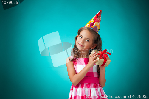 Image of The cute cheerful little girl on blue background