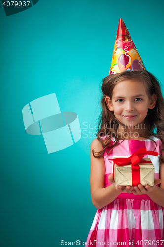 Image of The cute cheerful little girl on blue background