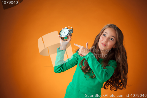 Image of The cute cheerful little girl on orange background