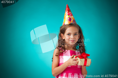 Image of The cute cheerful little girl on blue background