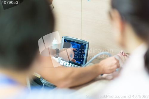 Image of Medical doctor student learning to use ultra sound scanner machine.