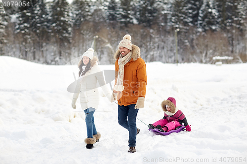 Image of happy family with sled walking in winter forest