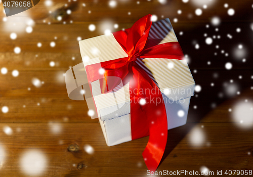 Image of close up of christmas  gift box on wooden floor