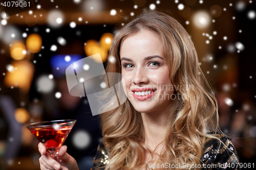 Image of glamorous woman with cocktail at night club or bar