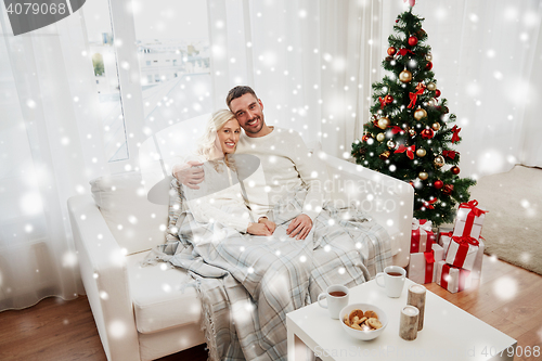 Image of happy couple at home with christmas tree