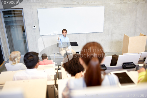 Image of group of students and teacher at lecture