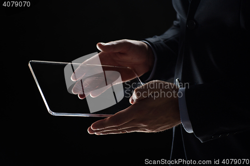 Image of close up of businessman with transparent tablet pc