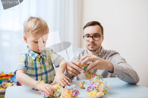 Image of father and son playing with ball clay at home