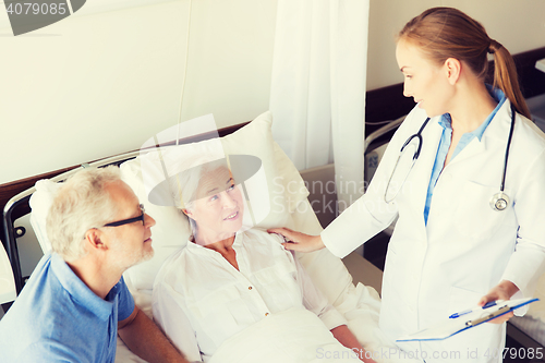 Image of senior woman and doctor with clipboard at hospital