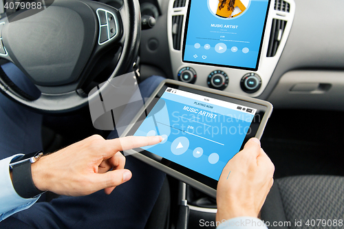 Image of close up of man with tablet pc in car