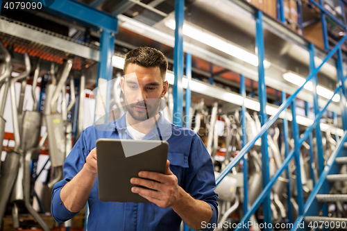 Image of auto mechanic or smith with tablet pc at workshop