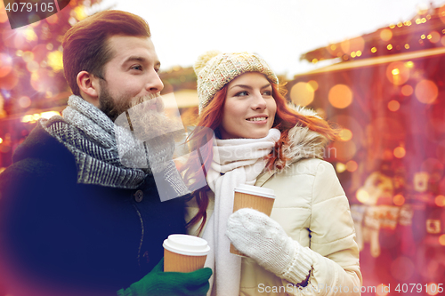 Image of happy couple drinking coffee on old town street
