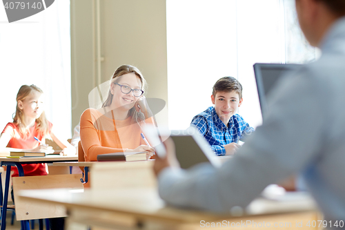 Image of group of students with books writing school test