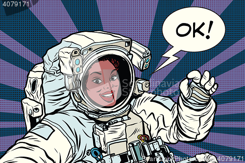 Image of OK gesture woman astronaut in a spacesuit