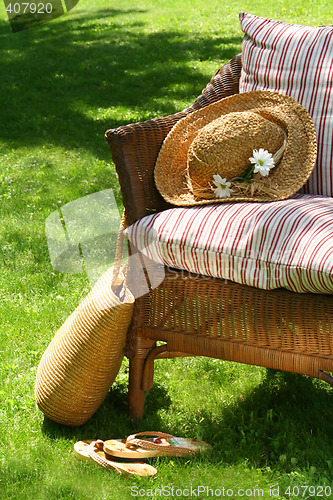 Image of Grass lawn with a wicker chair