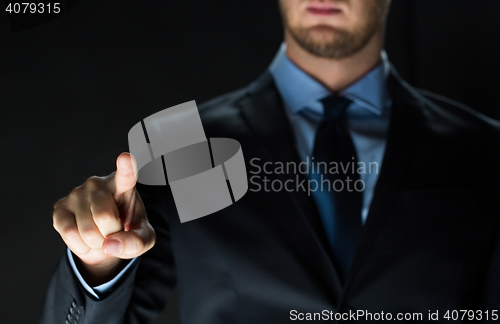 Image of close up of businessman touching virtual screen