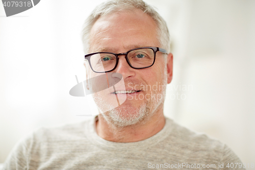 Image of close up of smiling senior man in glasses