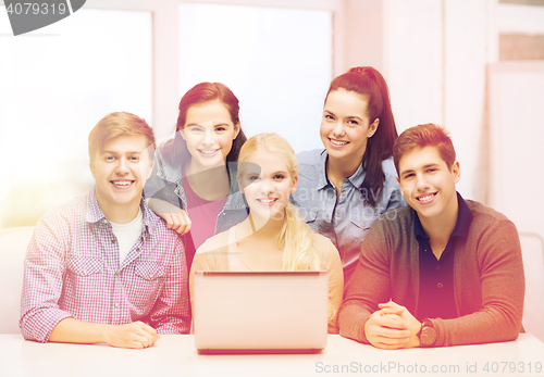 Image of smiling students with laptop at school