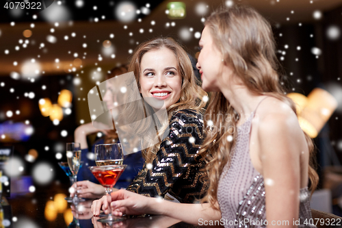 Image of happy women with drinks at night club