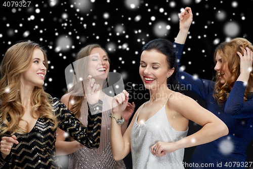 Image of happy young women dancing at night club disco