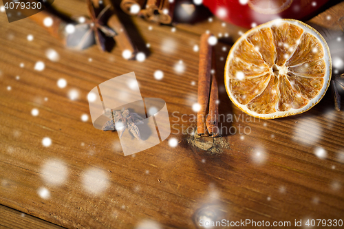 Image of cinnamon, anise and dried orange on wooden board