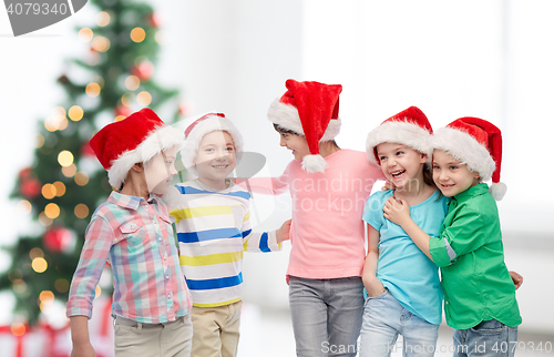 Image of happy little children in christmas santa hats