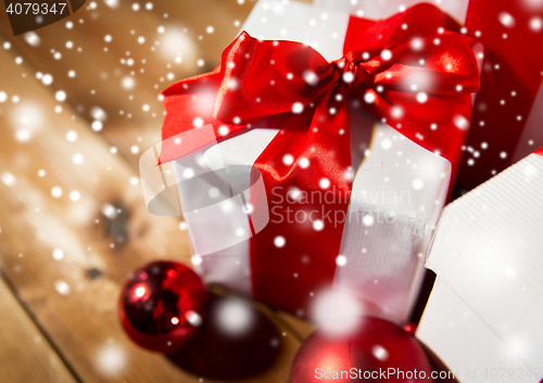 Image of close up of gift boxes and red christmas balls