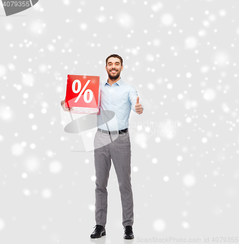 Image of smiling man with red percentage sign over snow