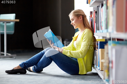 Image of high school student girl reading book at library