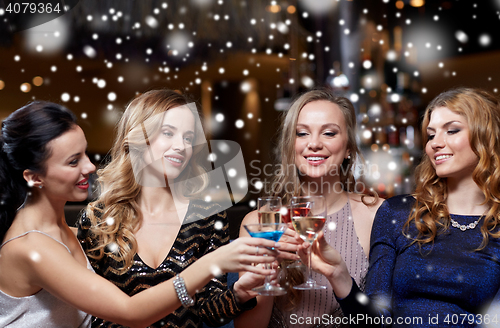 Image of happy women with drinks at night club