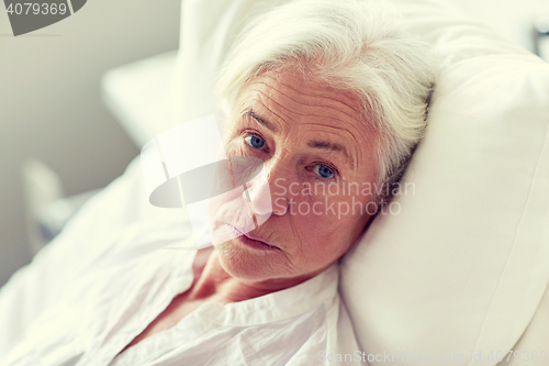 Image of senior woman patient lying in bed at hospital ward