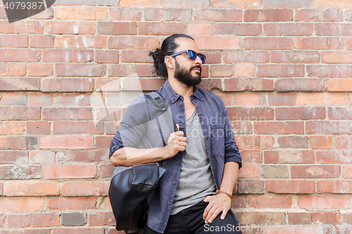 Image of happy man with backpack standing at city street