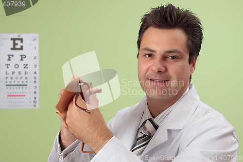 Image of Optician cleaning eye glasses