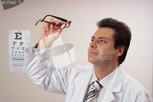 Image of Optometrist inspecting eye glasses