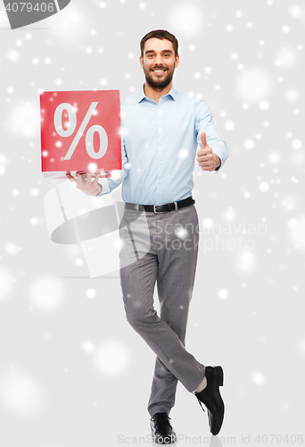 Image of smiling man with red percentage sign over snow