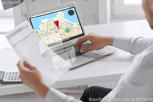 Image of businessman with laptop computer working at office