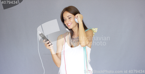 Image of Young woman listening to music at New Year