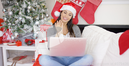 Image of Happy woman making a Christmas video chat