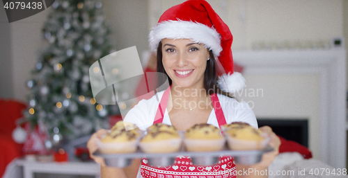 Image of Charming young woman with fresh baked cookies
