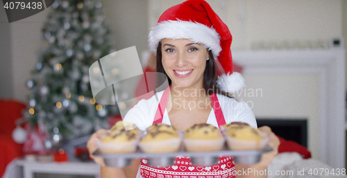 Image of Charming young woman with fresh baked cookies