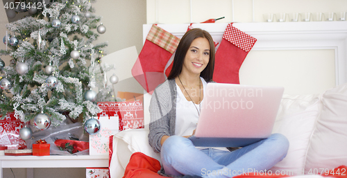 Image of Relaxed young woman working on her laptop