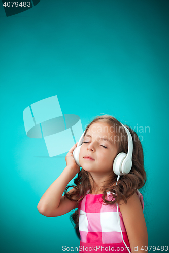 Image of The cute cheerful little girl on orange background