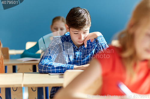 Image of group of students with books writing school test