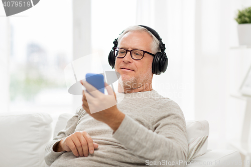 Image of happy senior man with smartphone and headphones