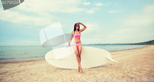 Image of smiling young woman with surfboard on beach